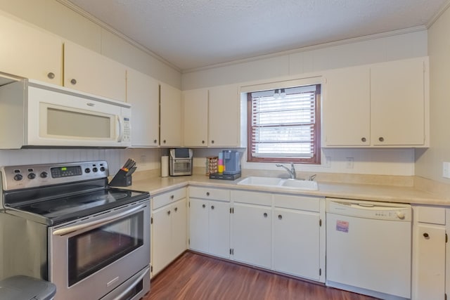 kitchen with sink, white appliances, and white cabinets