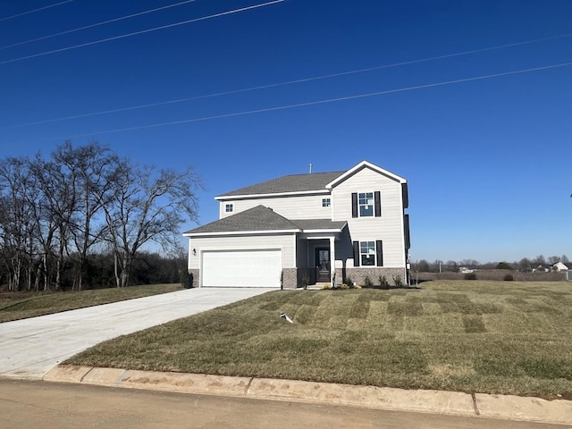 view of property featuring a garage and a front yard