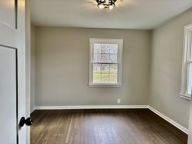 spare room with dark hardwood / wood-style flooring