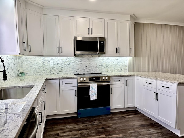 kitchen with sink, white cabinets, stainless steel appliances, and light stone counters