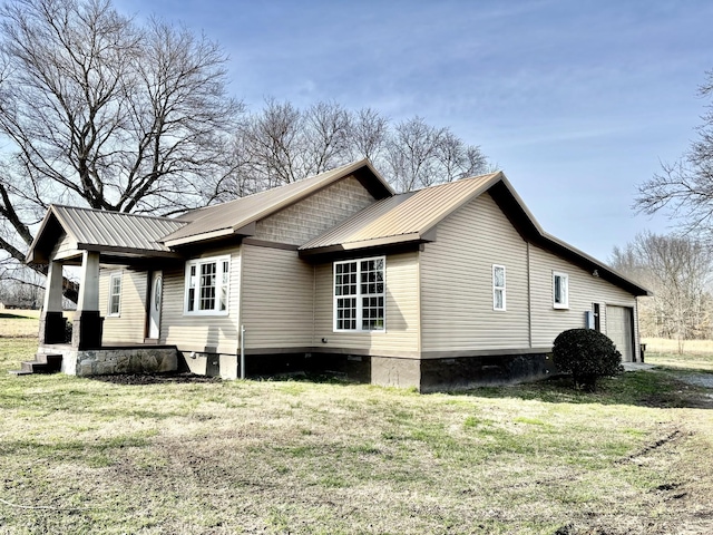 view of home's exterior featuring a garage and a lawn