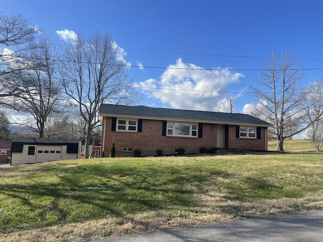 ranch-style home with a garage, an outbuilding, and a front lawn