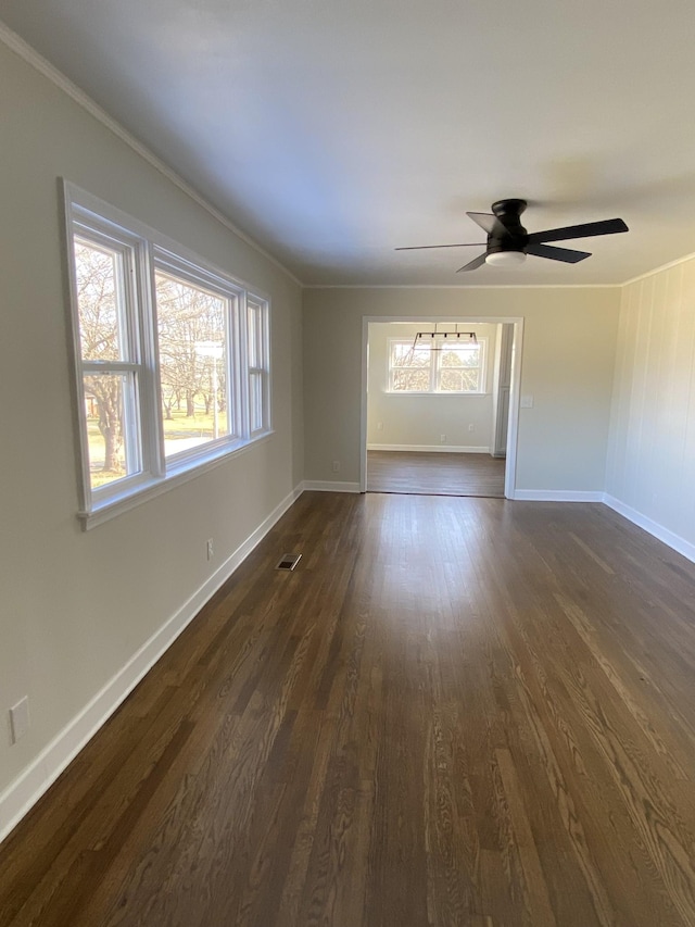 unfurnished room featuring ornamental molding, ceiling fan, and dark hardwood / wood-style flooring