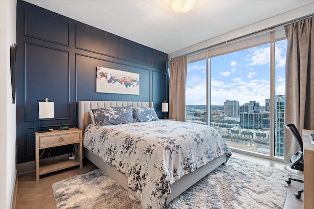 bedroom with light parquet floors and access to outside