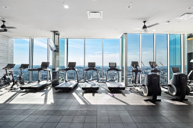 gym featuring expansive windows and ceiling fan