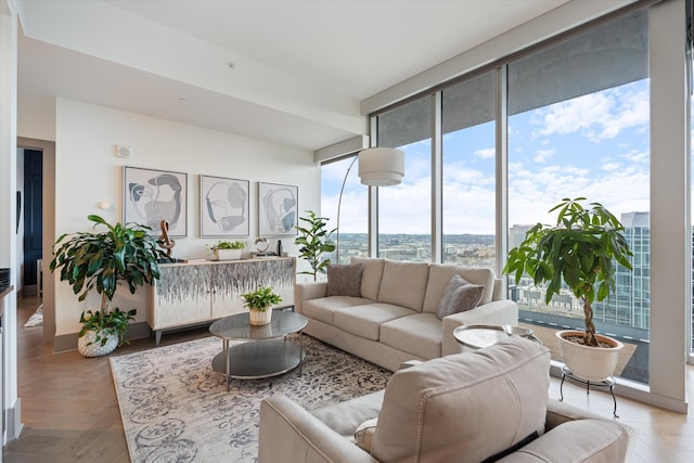 living room with parquet flooring and a wall of windows