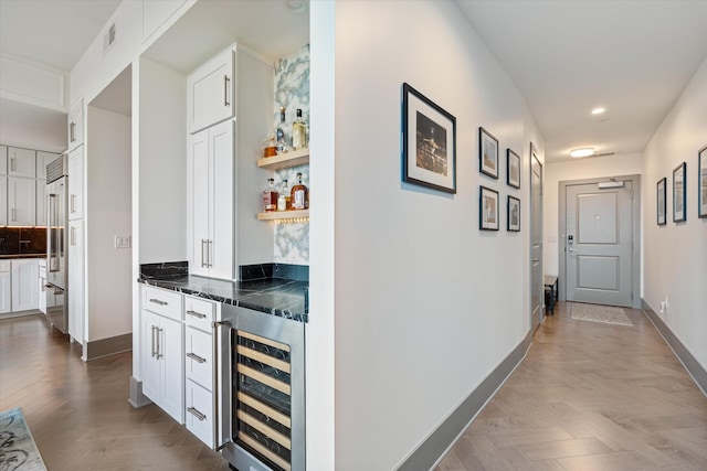 corridor with light parquet floors and wine cooler