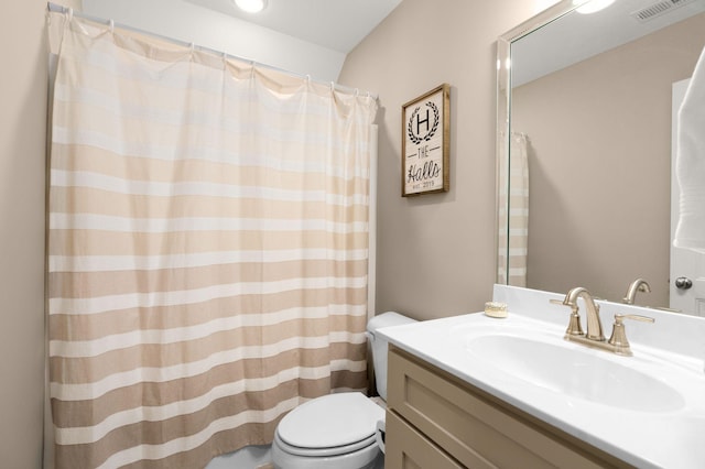 bathroom featuring toilet and vanity