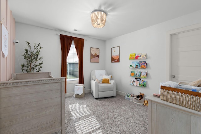 carpeted bedroom featuring a crib