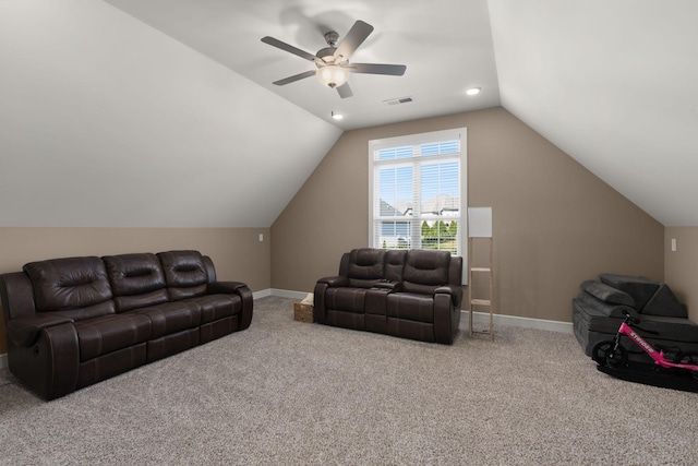 living room with ceiling fan, carpet floors, and lofted ceiling