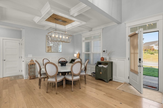 dining room featuring coffered ceiling, light wood-type flooring, beam ceiling, and ornamental molding