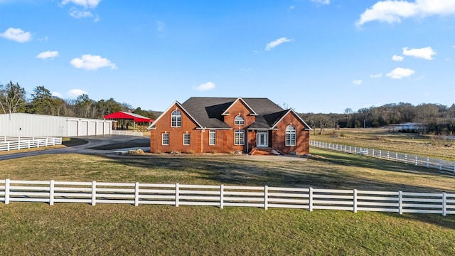 view of front facade with a front lawn and a rural view