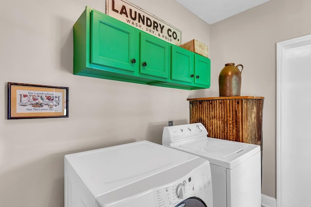 washroom featuring cabinets and washing machine and clothes dryer