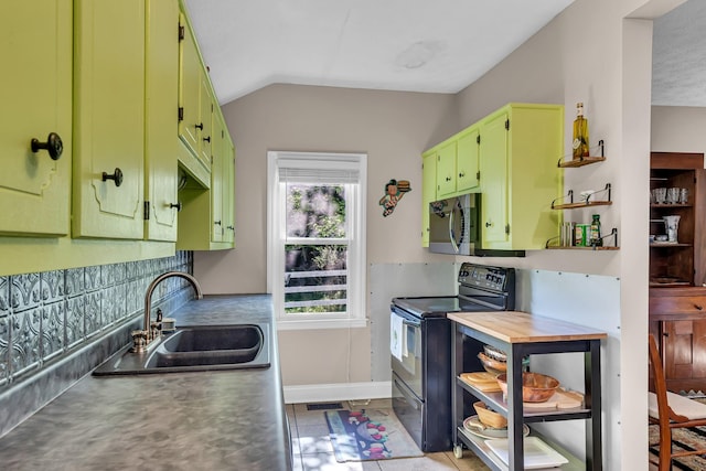 kitchen featuring sink, light tile patterned floors, vaulted ceiling, and black electric range