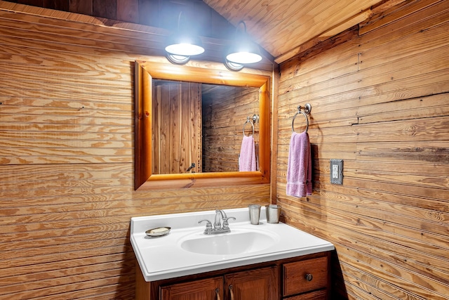 bathroom featuring vanity and wood walls