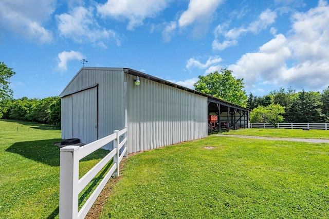 view of outbuilding featuring a yard