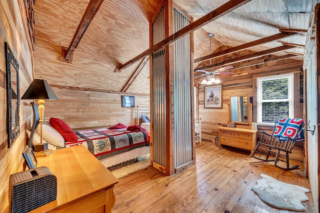 bedroom with hardwood / wood-style flooring, wooden walls, beam ceiling, and high vaulted ceiling