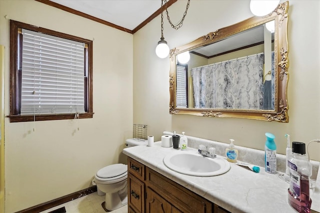 bathroom featuring toilet, vanity, and crown molding