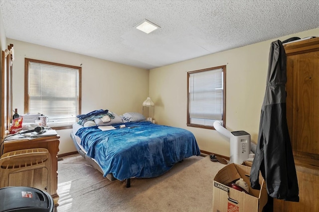 carpeted bedroom featuring a textured ceiling