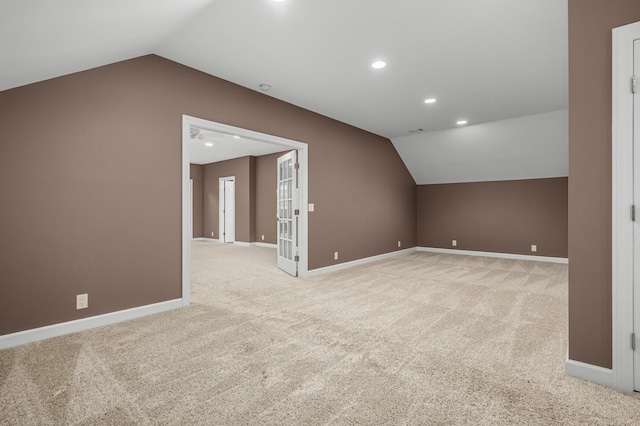 bonus room featuring light colored carpet and lofted ceiling