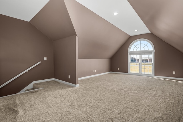 additional living space with carpet and lofted ceiling