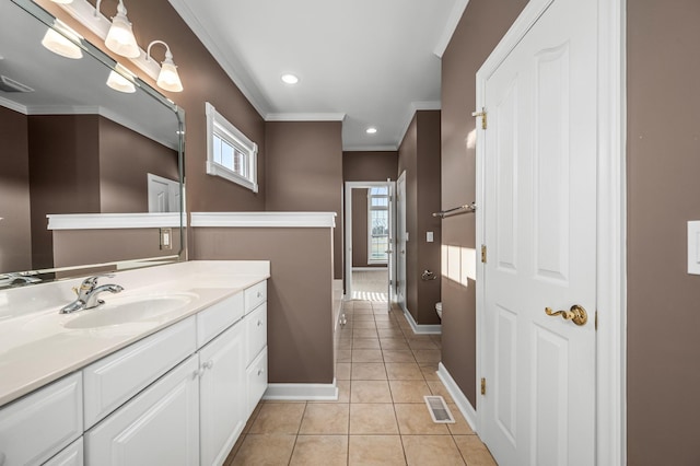 bathroom with ornamental molding, a healthy amount of sunlight, vanity, and tile patterned flooring