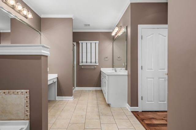 bathroom with vanity, crown molding, and tile patterned flooring