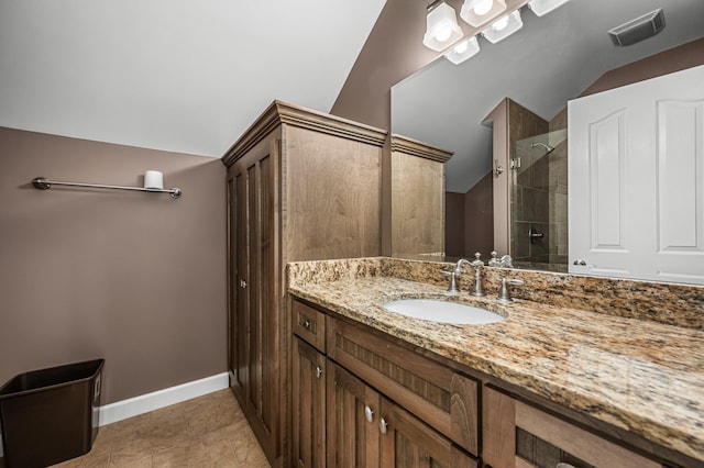 bathroom featuring walk in shower, tile patterned flooring, vaulted ceiling, and vanity