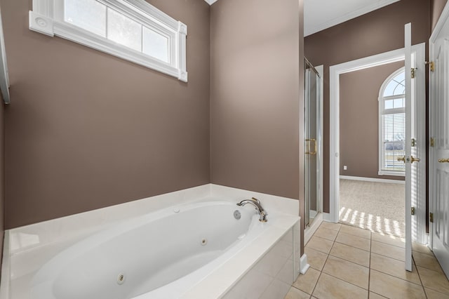 bathroom with a wealth of natural light, plus walk in shower, and tile patterned flooring