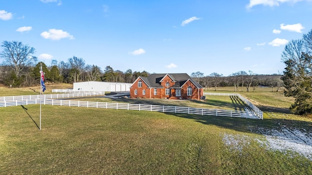 view of front of home featuring a rural view and a front lawn