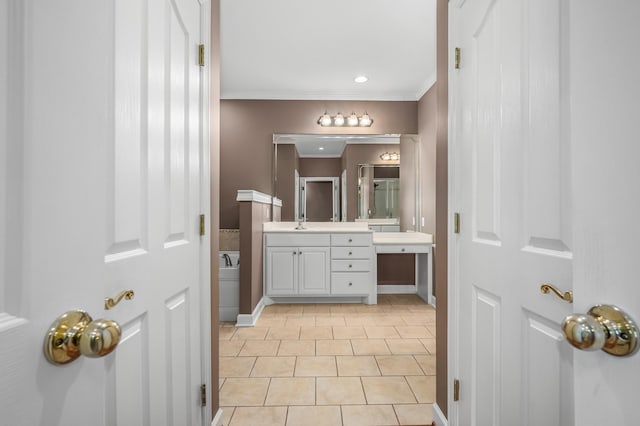 bathroom featuring vanity, crown molding, and tile patterned flooring