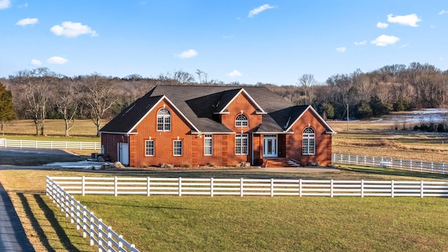 view of front of home featuring a front lawn and a rural view