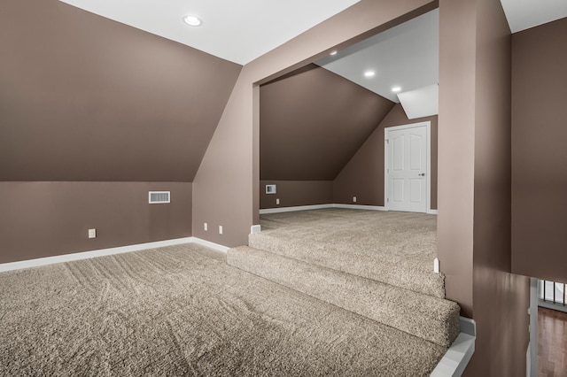 additional living space featuring carpet floors and lofted ceiling