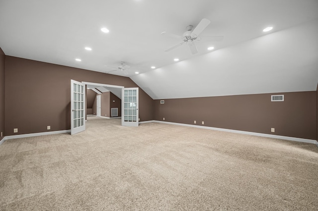 bonus room featuring ceiling fan, light carpet, lofted ceiling, and french doors