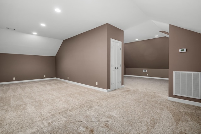 additional living space with light carpet and lofted ceiling