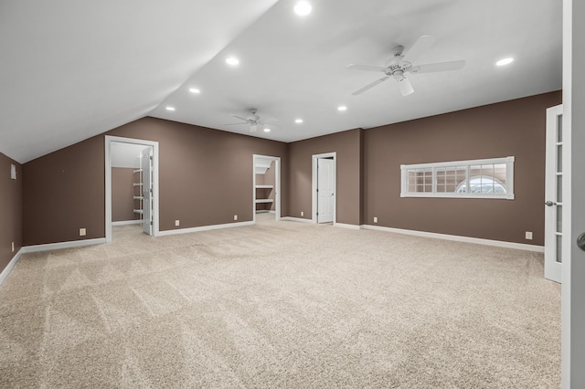 interior space featuring vaulted ceiling, ceiling fan, and light colored carpet