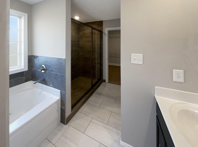 bathroom with sink, independent shower and bath, and tile patterned flooring