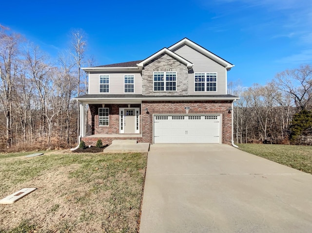 view of front of property featuring a front yard, a porch, and a garage