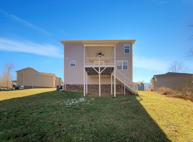 rear view of house with ceiling fan, a lawn, and central AC