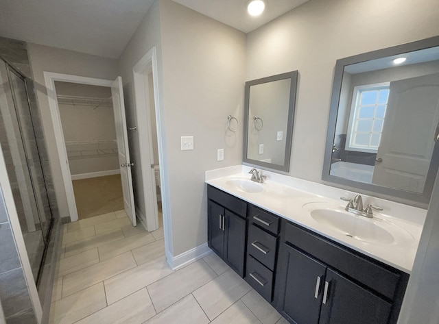 bathroom with vanity, a shower with shower door, and tile patterned flooring