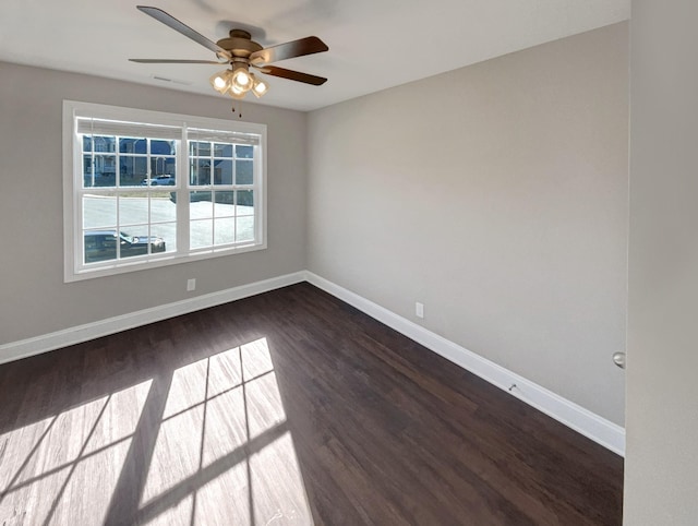 spare room featuring ceiling fan and dark hardwood / wood-style flooring