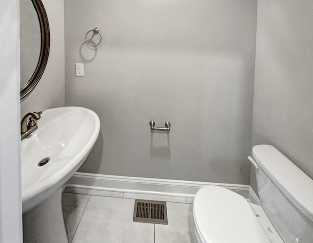 bathroom with toilet and tile patterned flooring