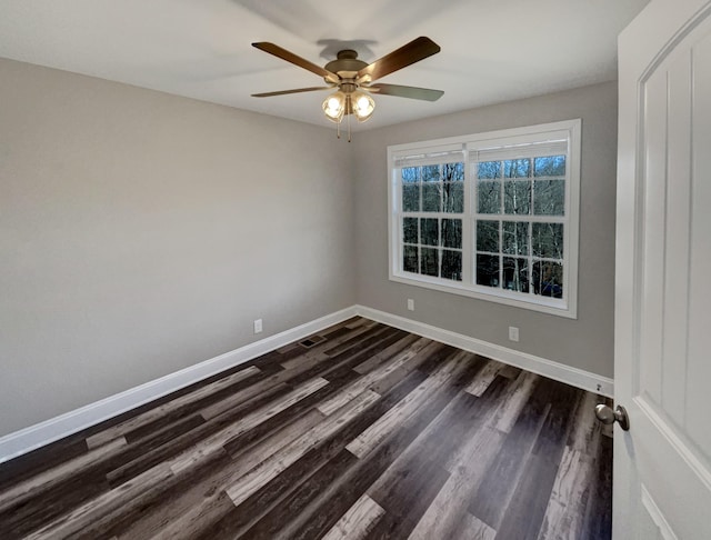 empty room featuring ceiling fan and dark hardwood / wood-style floors