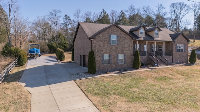 view of front of house with a front yard and a porch