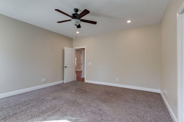 carpeted spare room with ceiling fan