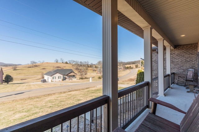 wooden deck featuring a rural view