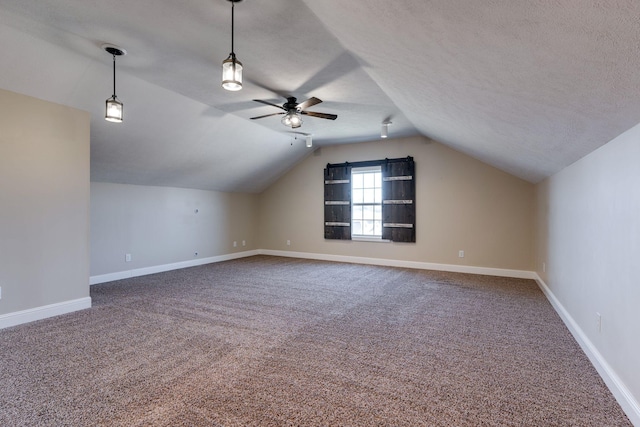 bonus room featuring ceiling fan, carpet floors, a textured ceiling, and vaulted ceiling