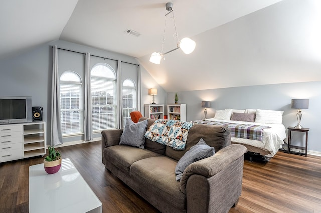 bedroom with dark wood-type flooring and lofted ceiling