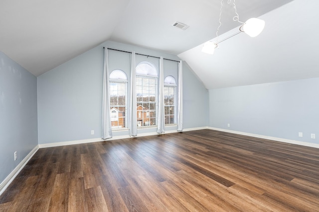 bonus room featuring dark wood-type flooring and vaulted ceiling