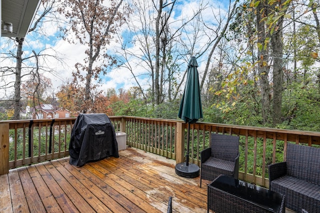 wooden terrace featuring a grill